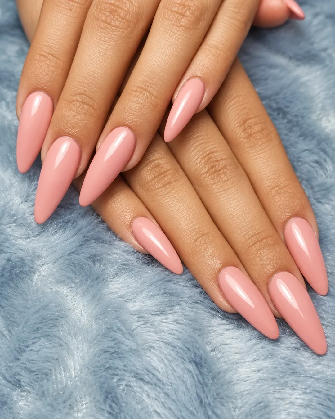 Long almond nails in a soft peach color
