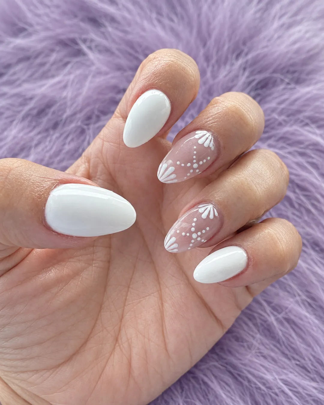 White almond nails with delicate white lace art on two accent nails