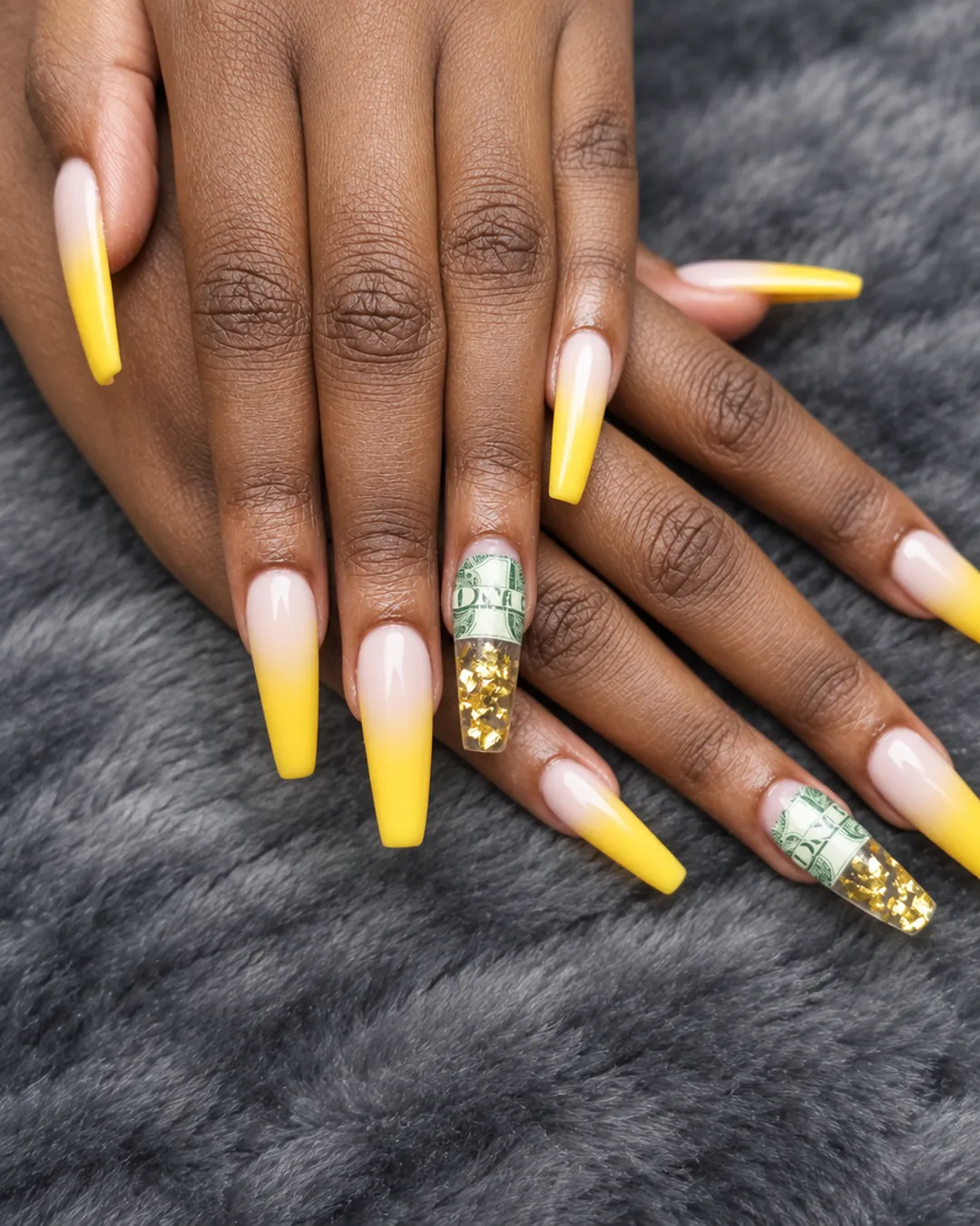 Long coffin nails with a yellow ombre fade and a gold-flake accent nail
