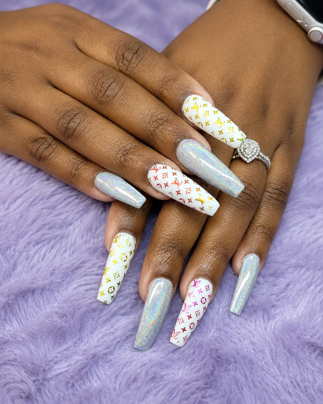 Long coffin nails in white and chrome silver with a monogram pattern